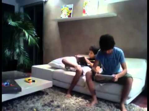 boy slaps his brother with the ipad